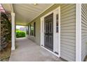 View of the front porch with a dark-colored front door and covered entrance at 1039 Steelechase Ln, Hanahan, SC 29410