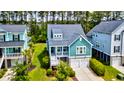 Bright home with a white porch, two-car garage, and manicured lawn at 104 Antilles Cir, Charleston, SC 29492