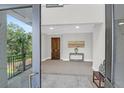 Welcoming foyer with a dark wood door, console table, and view to outdoor balcony at 108 Fairbanks Oak Aly # 401, Charleston, SC 29492