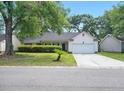 Traditional one-story home featuring a well-maintained front yard with mature trees at 109 New Spring Ct, Summerville, SC 29485