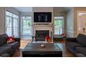 Bright living room features a fireplace and large windows at 111 Coltsgate Ct, Summerville, SC 29485