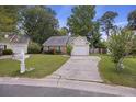 Lovely single-Gathering home with a driveway, garage, and a lush green lawn, creating a welcoming curb appeal at 111 Macfarren Ln, Summerville, SC 29485