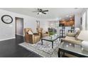 Inviting living room with an open layout, a ceiling fan, a patterned rug, and an eat-in kitchen with barstool seating at 1110 Flyway Rd, Summerville, SC 29483