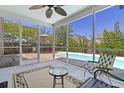 Relaxing screened porch with comfortable seating and views of the pool and backyard on a sunny day at 1110 Flyway Rd, Summerville, SC 29483