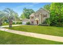 Inviting two-story home with well-manicured lawn and mature trees, exuding classic curb appeal at 113 Essex Dr, Summerville, SC 29485