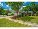Exterior of the property with a driveway leading to an attached garage and landscaped front yard at 115 Sully St, Goose Creek, SC 29445
