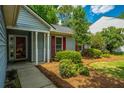 Close up of the home's entry featuring a covered porch and decorative shutters at 115 Sully St, Goose Creek, SC 29445