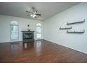 Spacious living room with hardwood floors, fireplace, and natural light from arched windows at 115 Sully St, Goose Creek, SC 29445
