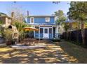 Charming backyard featuring a patio with outdoor seating, pizza oven and a well-maintained lawn, great for entertaining at 1153 King St, Charleston, SC 29403