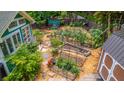Backyard garden featuring a green shed, a tool shed and planted, mulched garden beds at 1158 Shoreside Way, Mount Pleasant, SC 29464