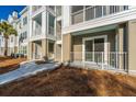 Exterior view of condo building features private patios with white railings and manicured grounds at 130 River Landing Dr # 7106, Charleston, SC 29492