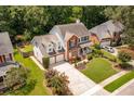 An aerial view shows a well-maintained property with mature trees, manicured lawns, and a long driveway at 143 Belleplaine Dr, Goose Creek, SC 29445