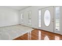 Airy living room with pristine white walls, hardwood floors, and natural light streaming through the windows at 143 Belleplaine Dr, Goose Creek, SC 29445