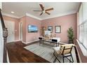 Home office with hardwood floors, natural light, ceiling fan, modern desk, and stylish decor enhance productivity at 1533 Bluewater Way, Charleston, SC 29414