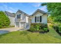 Charming two-story home with attached two-car garage, manicured lawn, and blooming flower beds at 1582 Ocean Neighbors Blvd, Charleston, SC 29412