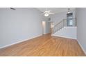 Bright and airy living room features vaulted ceiling, hardwood floors, and staircase at 1582 Ocean Neighbors Blvd, Charleston, SC 29412