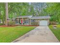 Beautiful brick home featuring an attached garage and a long driveway for multiple vehicles at 206 Jimbo Rd, Summerville, SC 29485