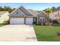 Charming single-Gathering home featuring a two-car garage, manicured lawn, and beautiful brick and siding details at 209 Celestial Blvd, Summerville, SC 29486