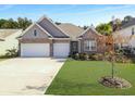 Charming single-Gathering home featuring a two-car garage, manicured lawn, and beautiful brick and siding details at 209 Celestial Blvd, Summerville, SC 29486