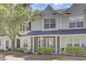 Charming townhome featuring a well-maintained yard, brick facade, and a welcoming entryway at 302 Elm Hall Cir, Summerville, SC 29483