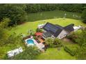 Aerial view of the home with a pool, pond, pergola, solar panels, and ample green space at 3113 Edenvale Rd, Johns Island, SC 29455