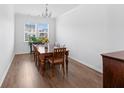 Bright dining room with wood floors, table, chairs, and natural light from windows at 320 Blue Shadows Ct, Summerville, SC 29486