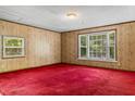 Spacious bedroom with bright red carpet, decorative wallpaper and large windows for ample natural light at 3249 Stonehaven Dr, North Charleston, SC 29420