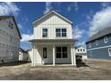 A two-story home with white siding and a welcoming front porch under a blue sky at 337 Trailmore Ln, Summerville, SC 29486