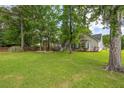 Expansive lawn area with mature trees and the rear exterior view of the house at 420 Manorwood Ln, Charleston, SC 29414