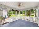 A screened porch with white lattice railings overlooking a large yard and pond at 420 Manorwood Ln, Charleston, SC 29414