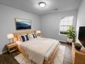 This well lit main bedroom features hard wood floors, accent art, and natural light at 4500 Winterwood Pl, Ladson, SC 29456