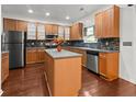 Well-equipped kitchen with wood cabinets, stainless steel appliances, and a center island at 5404 Red Fork Ln, North Charleston, SC 29420