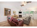 Bright living room with vaulted ceilings, a cozy fireplace, and comfortable seating at 541 Brick Barn Ln, Goose Creek, SC 29445