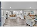 Open-concept kitchen and living area featuring new stainless steel appliances and sleek countertops at 718 Parish Rd, Charleston, SC 29407