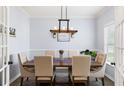 Elegant dining room featuring a wooden table, upholstered chairs, and stylish lighting fixtures, perfect for gatherings at 8402 Loggers Run, North Charleston, SC 29420
