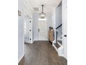 Welcoming foyer with hardwood floors, neutral paint, decorative lighting, and an entry to the living space at 8402 Loggers Run, North Charleston, SC 29420