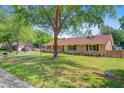 Charming one-story brick home with a large front yard and mature trees providing ample shade at 924 Trent St, Charleston, SC 29414