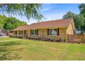 Well-maintained one-story brick home with mature landscaping and a lush green lawn at 924 Trent St, Charleston, SC 29414