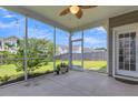 Relaxing screened-in porch with a ceiling fan and string lights, perfect for outdoor enjoyment at 9998 Winged Elm St, Ladson, SC 29456