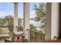Balcony view of pier and harbor featuring comfortable seating and wrought iron railing at 108 Fairbanks Oak Aly # 302, Daniel Island, SC 29492