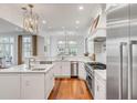 Bright and spacious kitchen with hardwood floors, stainless steel appliances, and marble countertops at 108 Fairbanks Oak Aly # 302, Daniel Island, SC 29492