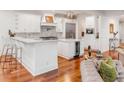 Modern kitchen featuring white cabinets, marble countertops, wine cooler, and stainless steel appliances at 108 Fairbanks Oak Aly # 302, Daniel Island, SC 29492