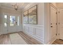 Bright entryway featuring wainscoting, wood floors, and a front door with glass panels allowing natural light at 114 Headwater Dr, Summerville, SC 29486