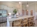 Spacious kitchen island featuring white countertops, stainless steel appliances, and seating at 114 Headwater Dr, Summerville, SC 29486