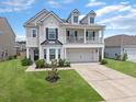 Inviting home with manicured lawn, and charming architectural details at 115 Daniels Creek Cir, Goose Creek, SC 29445