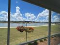 Enjoy the serene view of the lake from this home's screened porch, complete with hanging flower baskets at 1273 Locals St, Summerville, SC 29485