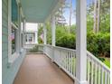 Inviting covered porch with white railing and ample space for outdoor seating or relaxing with nature at 1348 Seaside Plantation Dr, Charleston, SC 29412