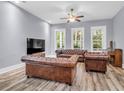 Cozy living room featuring hardwood floors, plentiful natural light, and comfortable leather seating arrangement at 1348 Seaside Plantation Dr, Charleston, SC 29412