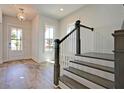 Inviting entryway with wood flooring, a staircase, and a front door with glass panels at 1423 Clay Field Trl, Summerville, SC 29485