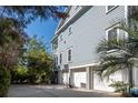 View of home's side showcasing the garage, basketball hoop, and access to outdoor space at 1543 Wando Landing St, Charleston, SC 29492